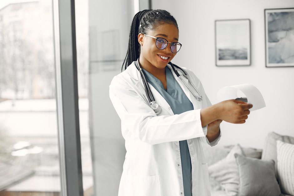 Smiling female doctor in glasses and stethoscope holding a document indoors.