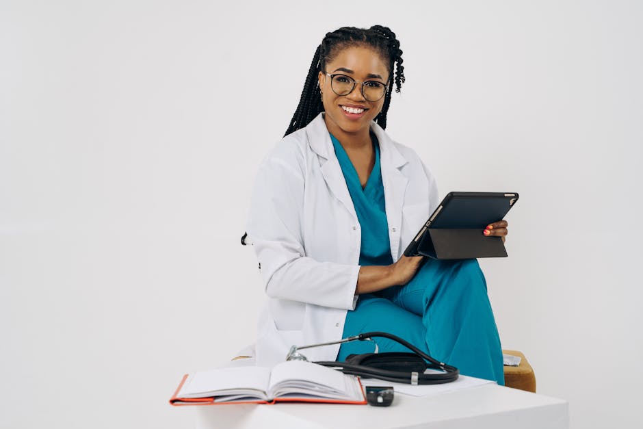 Smiling female doctor with a tablet and stethoscope in a bright office setting.