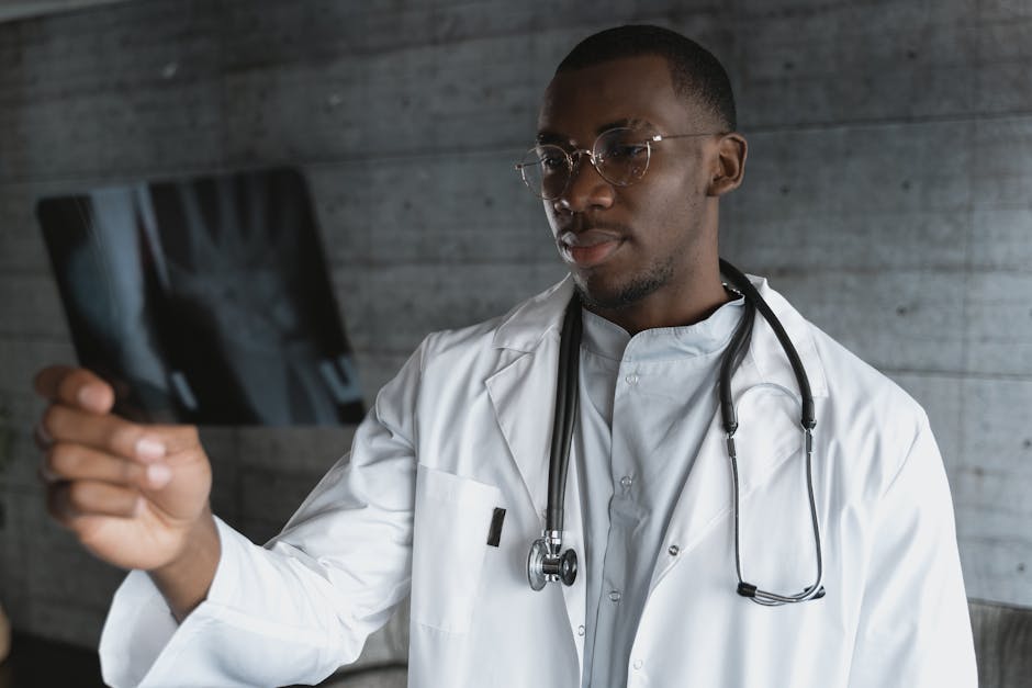 Professional doctor with eyeglasses reviewing an X-ray indoors.